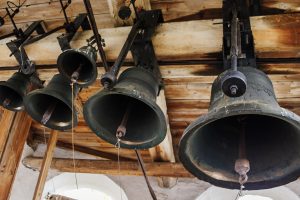 Old Big Black Bells on Old-school Church Tower.
