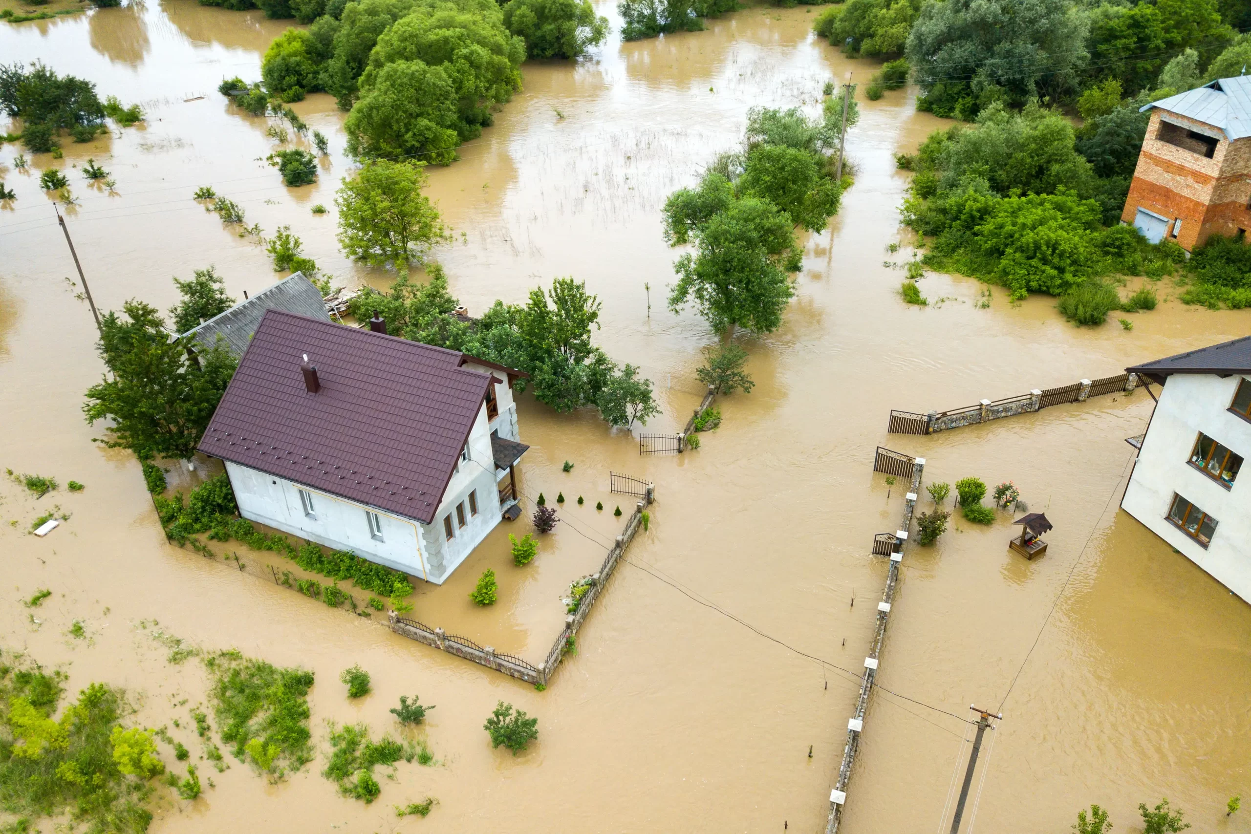 aerial view of flooded house with dirty water from California's atmospheric river rain causing a flood. 2024