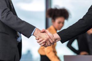 business people shaking hands because of easier work flow created by HQE Systems and their SiSA software