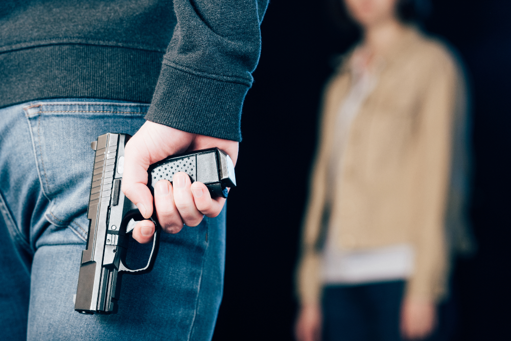 Gunman in Public while a lady is standing across from him