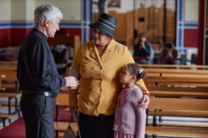woman with daughter at church being protected with life safety integration for Faith Based Operations by HQE Systems.
